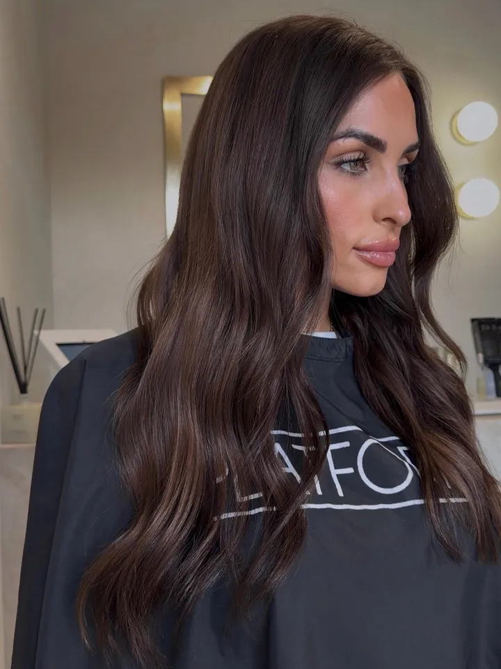 Real client wearing Premium Pro Wefts, side profile of a seamless brunette blend