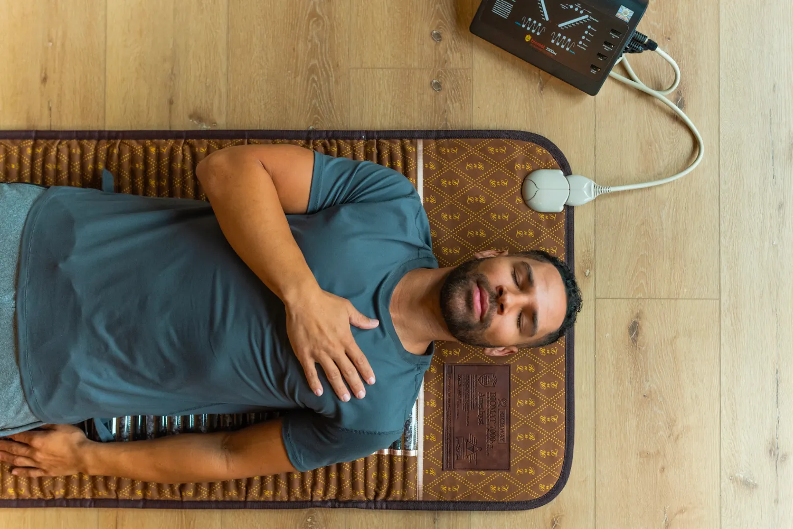 Man resting on a full-length BioMat Professional