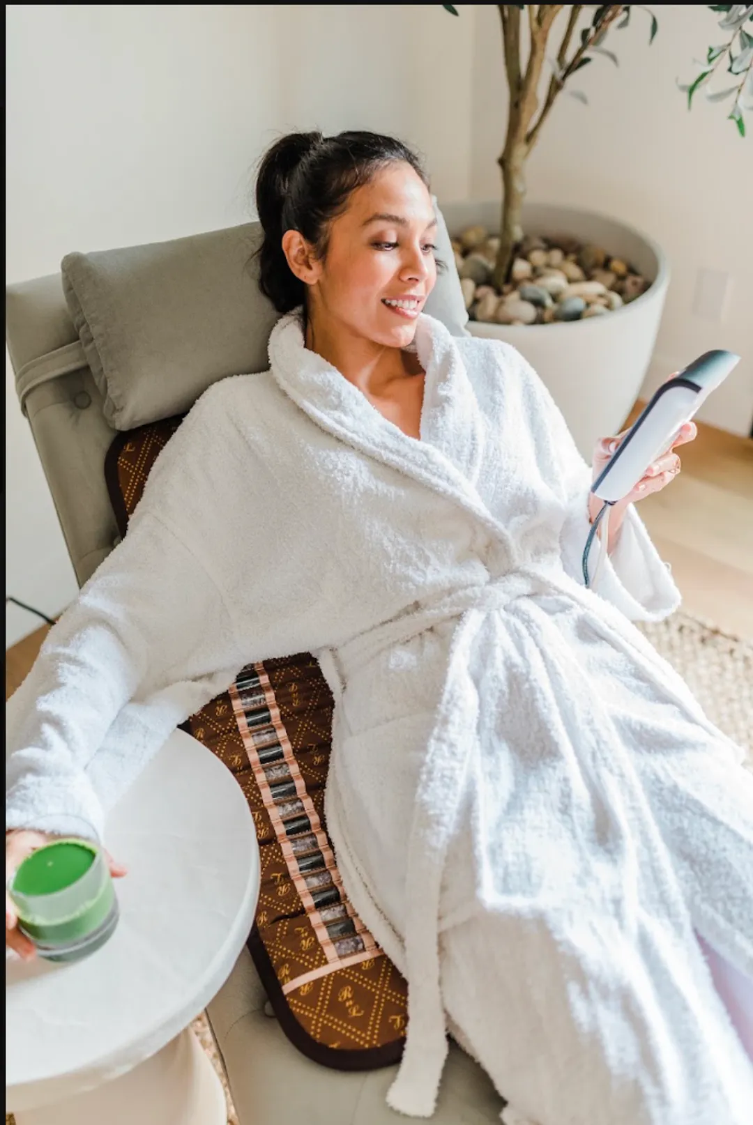 Woman relaxing in a chair with a BioMat Mini